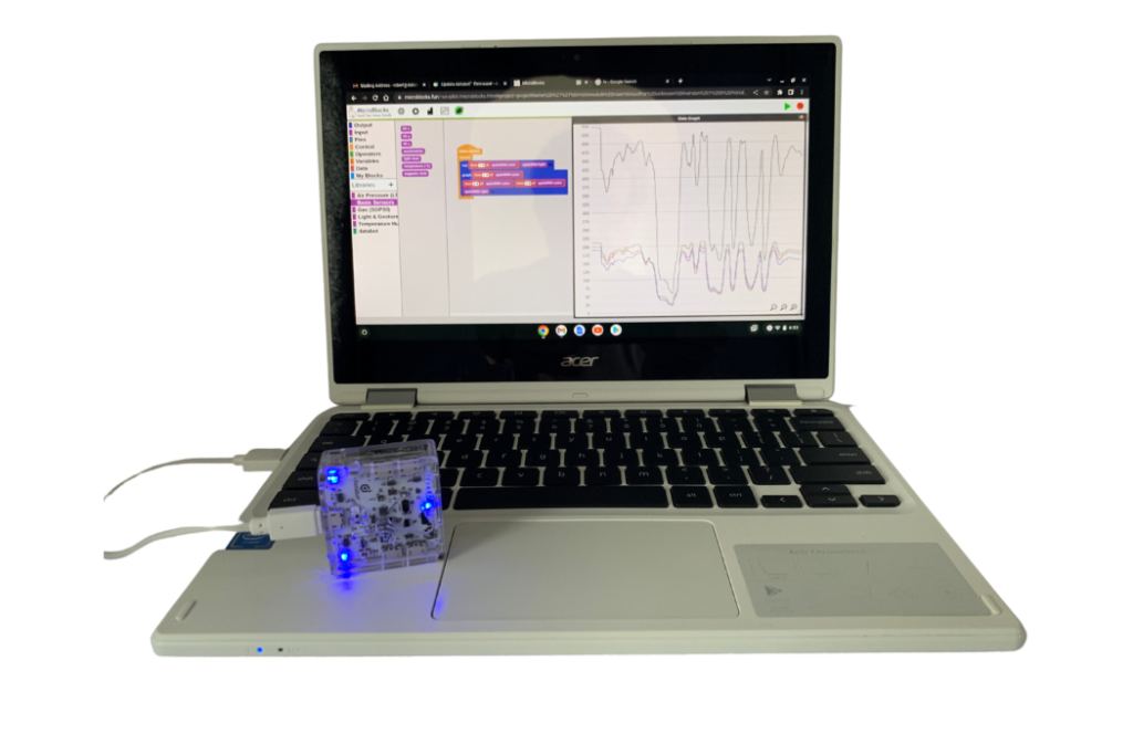 Chromebook running MicroBlocks coding databot sensors to display graphing data.